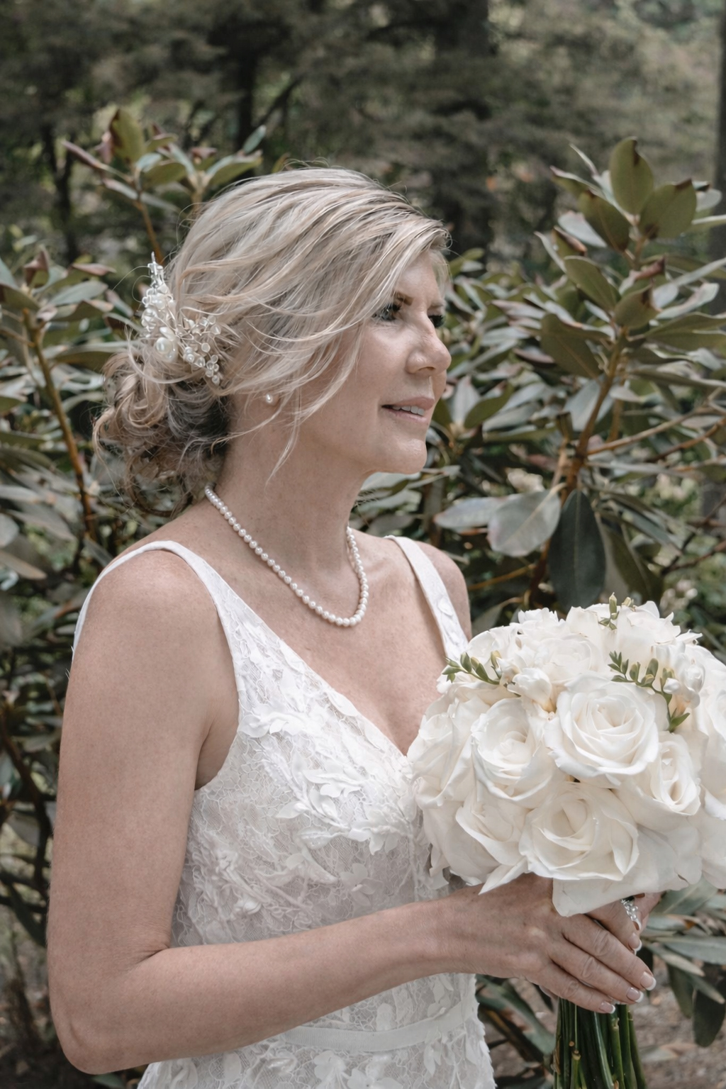 Bride holding a white anemone wedding bouquet