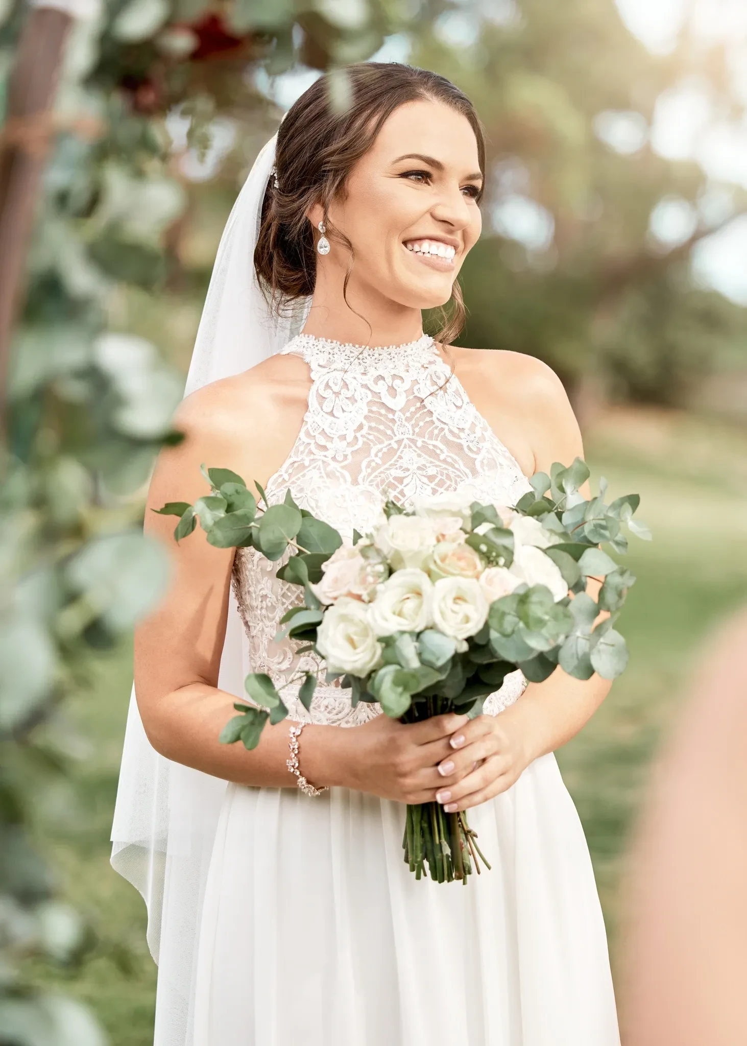 Bride holding white rose bouquet