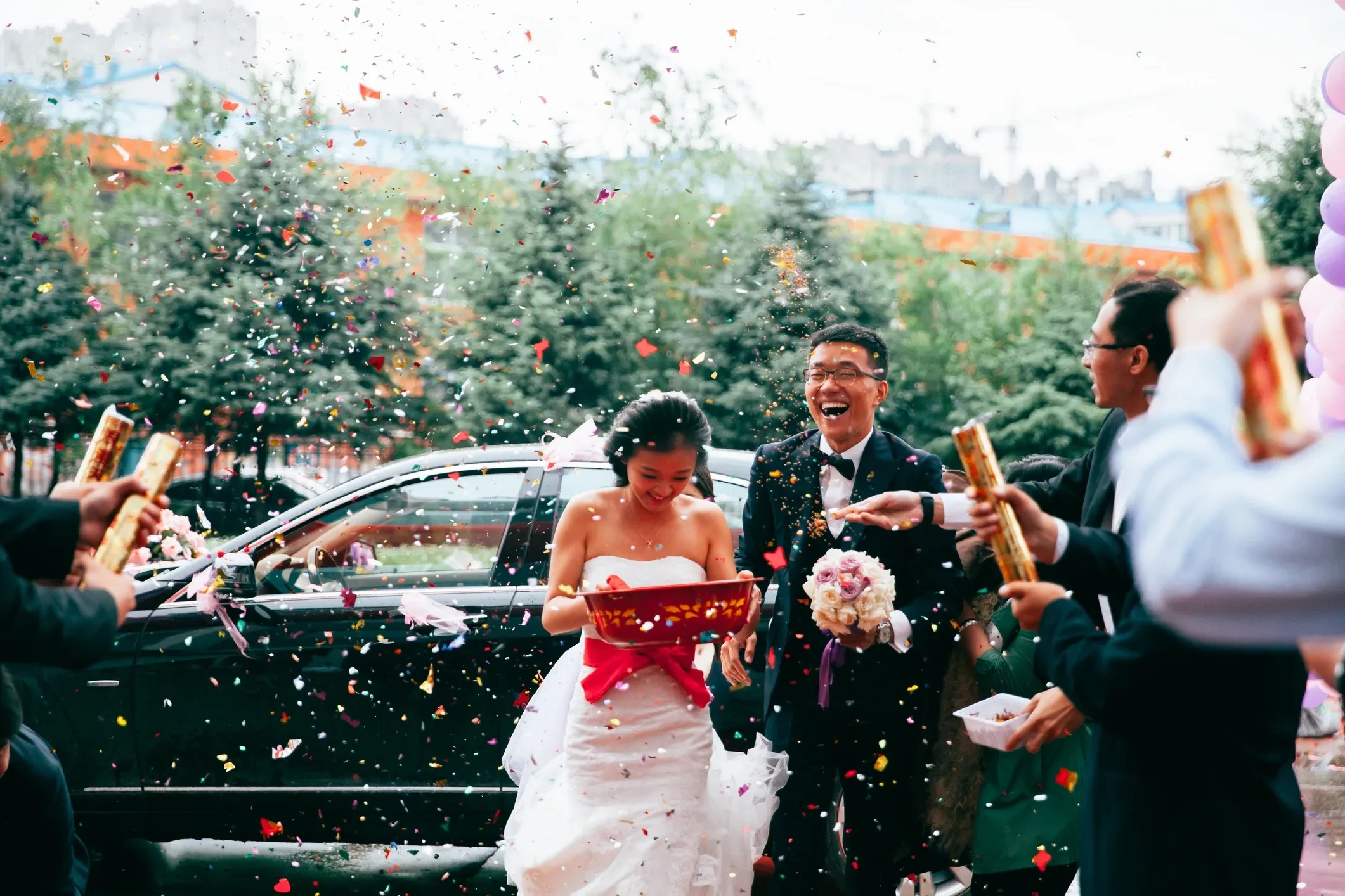 Bride and groom arriving by limousine on their wedding day