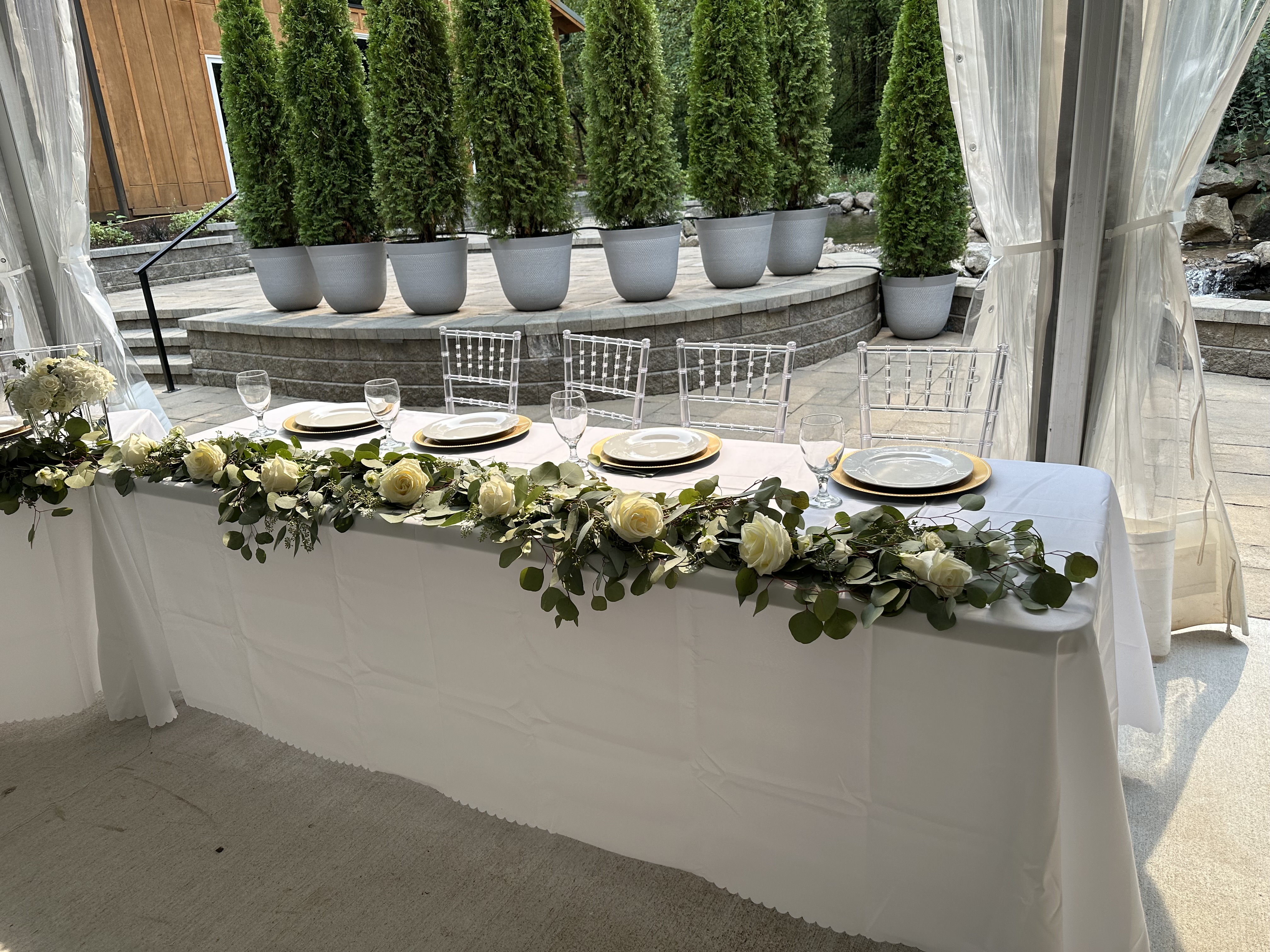 Sweetheart table with eucalyptus and white rose garland